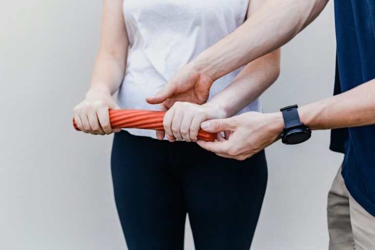 Athlete performing a supervised mobility exercise while a clinician observes movement and alignment.